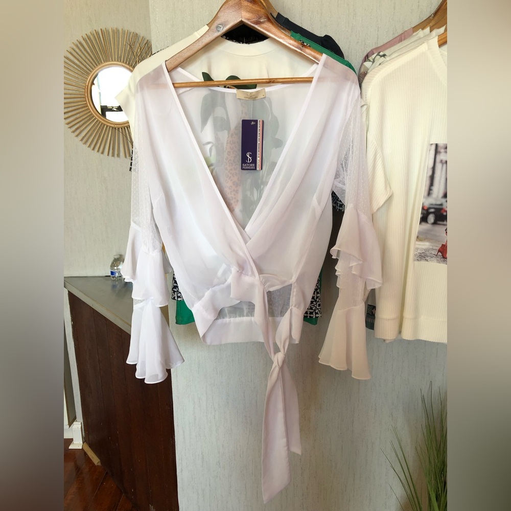 White blouse with lace detail on sleeves.